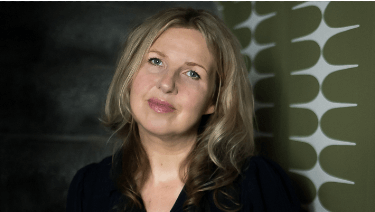 Melanie Barnes sitting on the stairs Melanie Barnes Elixir Interior Design